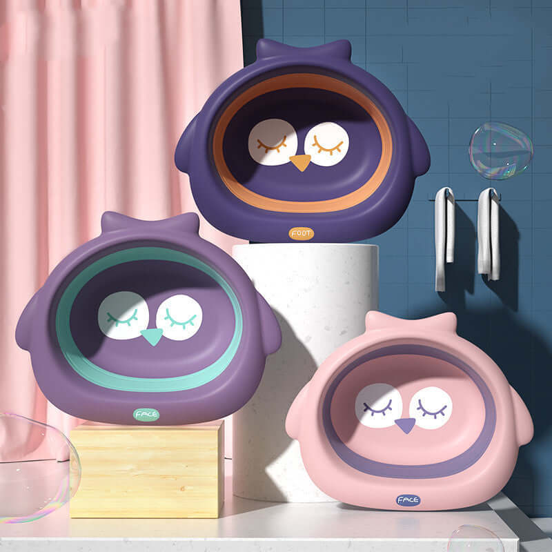 Three baby buttocks small basins in purple and pink hues, designed for children's products, displayed in a modern bathroom setting.