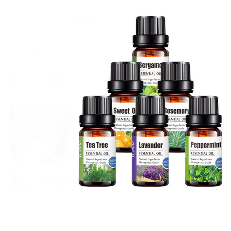 "Assorted essential oil bottles including tea tree, lavender, peppermint, bergamot, sweet orange, and rosemary for aromatherapy and massage"