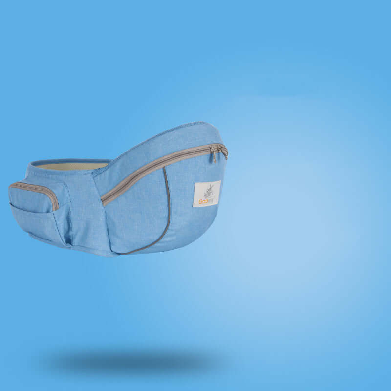 Denim blue children's sling baby carrier waist stool with zipper pockets against a blue background.