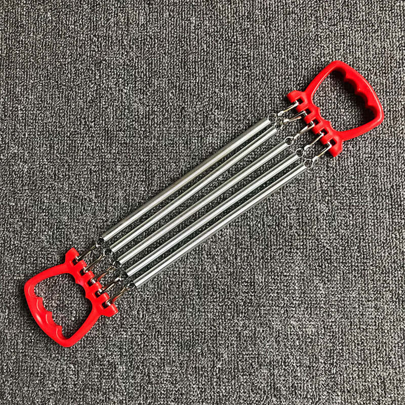 Chest expander training exercise equipment with carbon springs and red ABS plastic handles on a textured grey background