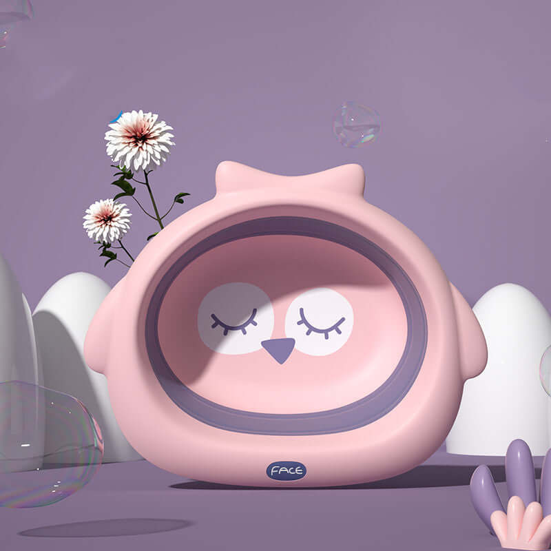 Pink owl-shaped baby basin with soft fog powder color, surrounded by flowers and bubbles, suitable for children's bath time.
