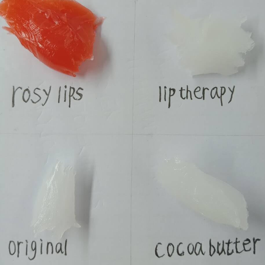 Various lip balm textures labeled as rosy lips, lip therapy, original, and cocoa butter on a white background.