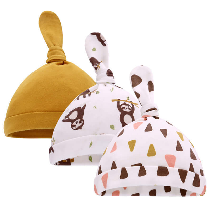 Baby hats in mustard yellow and cartoon prints, featuring sloths and geometric patterns, suitable for Spring and Autumn, made of pure cotton.