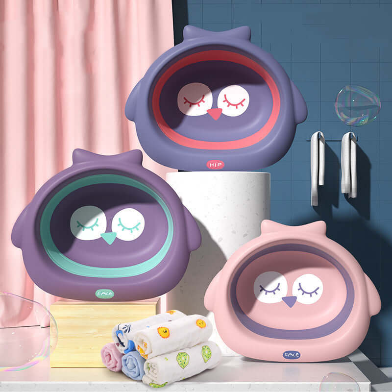Cute owl-shaped baby basins in soft fog powder, dark night purple, and deep blue colors, displayed with children's towels in modern bathroom setting.