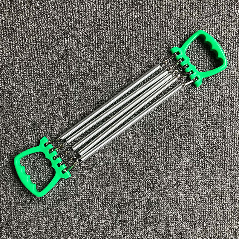Chest expander training exercise equipment with carbon springs and green ABS plastic handles on grey background.