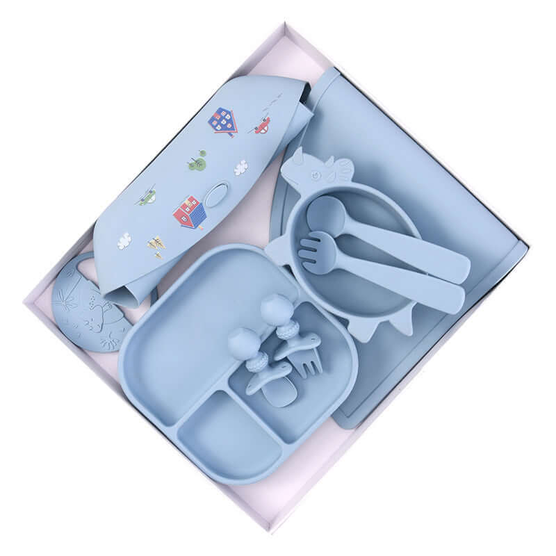 Silicone baby tableware set in blue with mat, plate, bowl, knife, and fork for infants over 3 months, made of durable silica gel material.