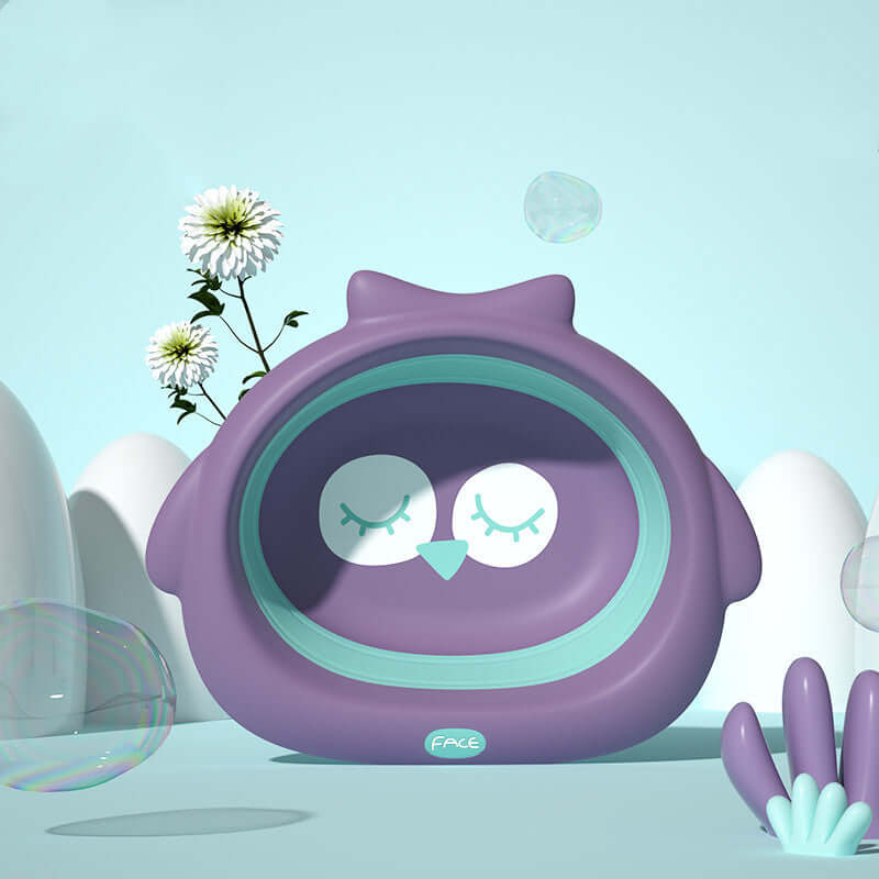 Purple owl-shaped baby basin with a turquoise accent, surrounded by bubbles and flowers in a whimsical scene.