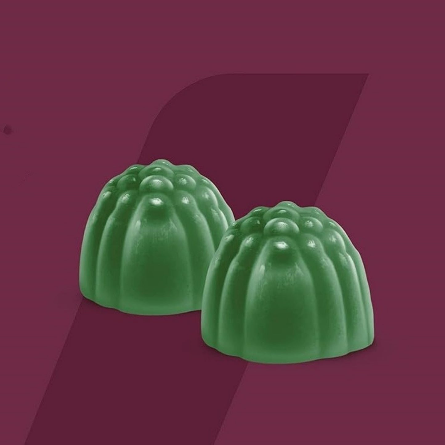 Aloe Vera Gummies on a burgundy background, showcasing their soft texture and green color, ideal for cool, dry storage conditions.