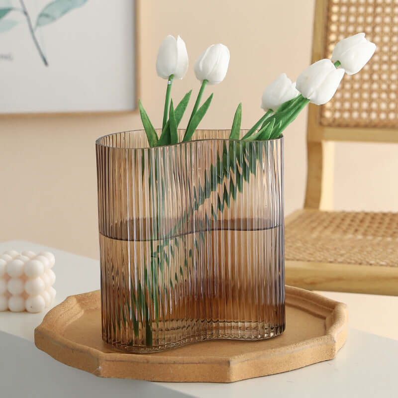 Hydroponic flowers in a transparent glass vase for elegant living room desktop decoration"