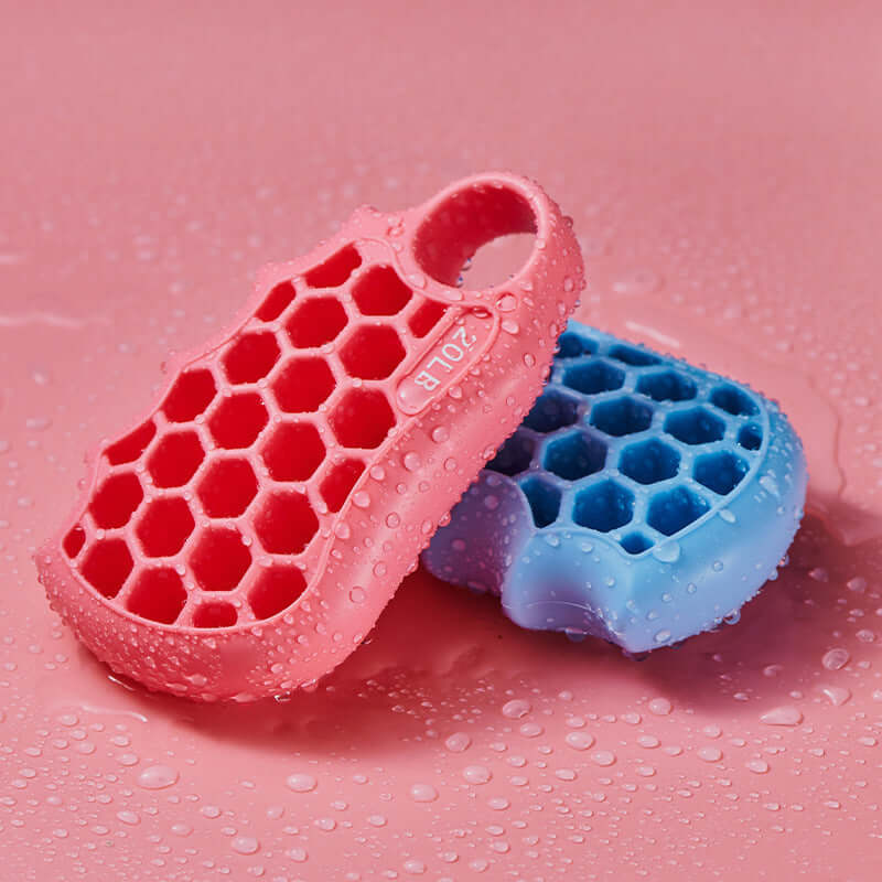 Honeycomb grip fitness exercise silicone equipment in pink and sky blue on wet surface.
