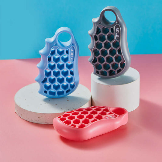Silicone honeycomb grip fitness exercise equipment in pink, sky blue, and grey colors displayed on a pastel background