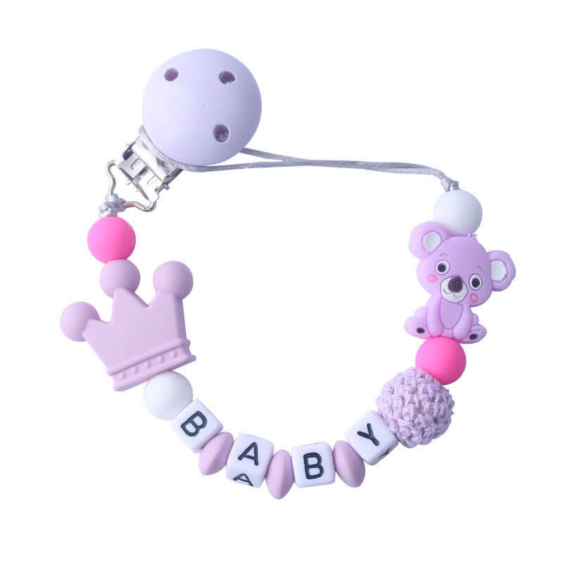 Silicone and wood pacifier clip chain with "BABY" letters, pink beads, crown, and koala design for babies.
