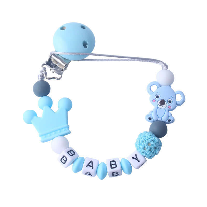 Blue baby pacifier clip with silicone and wood beads, featuring "BABY" letters, a crown, and a cute bear design.