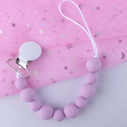 Pink silicone pacifier clip chain with metal clasp on star-patterned background for babies over 3 months
