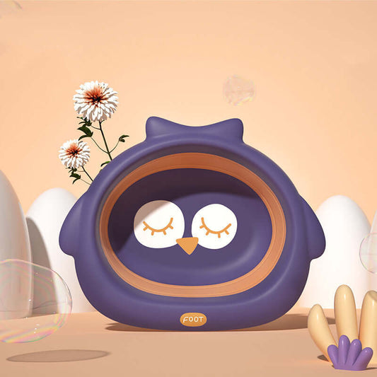 Purple owl-shaped small basin for babies and children, perfect for bath time, surrounded by flowers and soft pastel decorations.