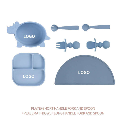 Silicone baby tableware set with blue plate, bowl, short and long handle forks and spoons, and a placemat, suitable for babies over 3 months.